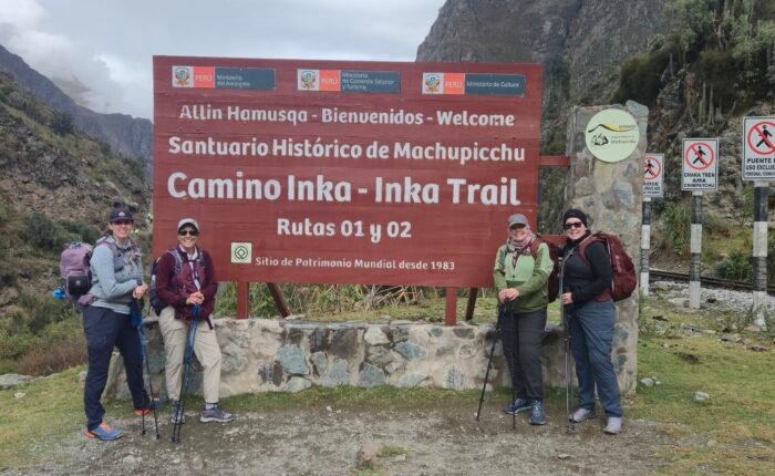 Hikers walking along the ancient stone paths of the Classic Inca Trail 4 Days to Machu Picchu, surrounded by breathtaking Andean mountains and lush cloud forest. This iconic trek combines stunning landscapes, Inca archaeological sites, and the unique experience of arriving at Machu Picchu through the Sun Gate.