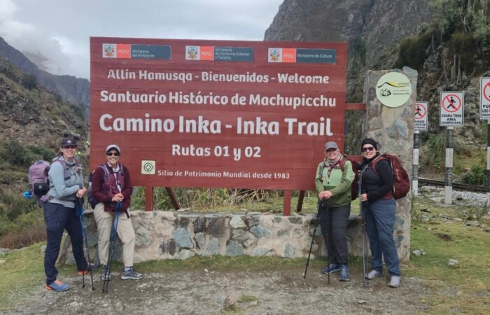 Hikers walking along the ancient stone paths of the Classic Inca Trail 4 Days to Machu Picchu, surrounded by breathtaking Andean mountains and lush cloud forest. This iconic trek combines stunning landscapes, Inca archaeological sites, and the unique experience of arriving at Machu Picchu through the Sun Gate.