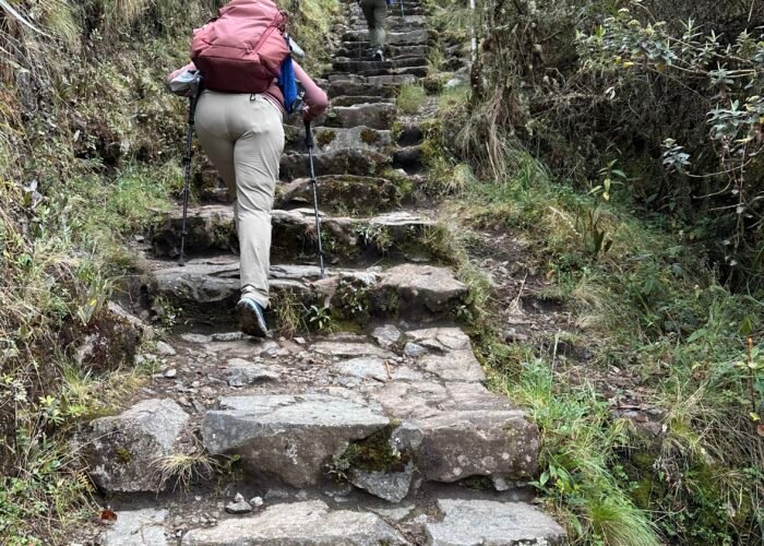 Inca Trail to Machu Picchu 2026 — archaeological ruins surrounded by mountains and misty landscapes.