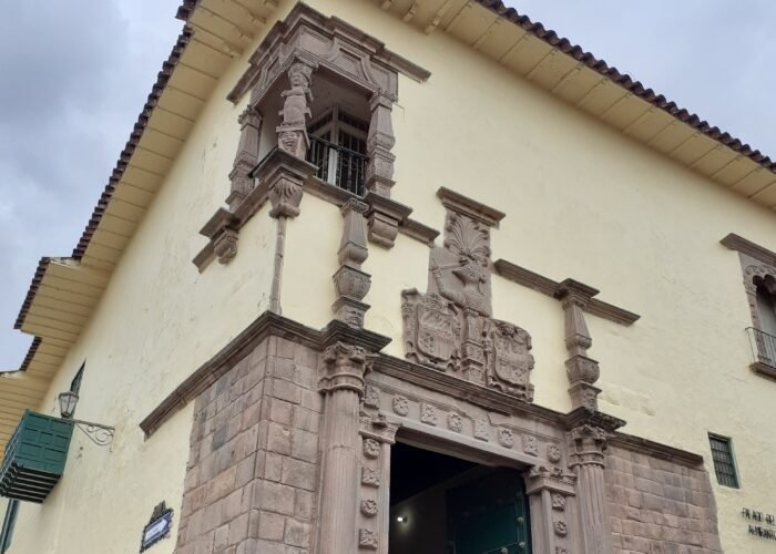 Historic façade of the Inka Museum in Cusco featuring the Dragon Ship relief detail.