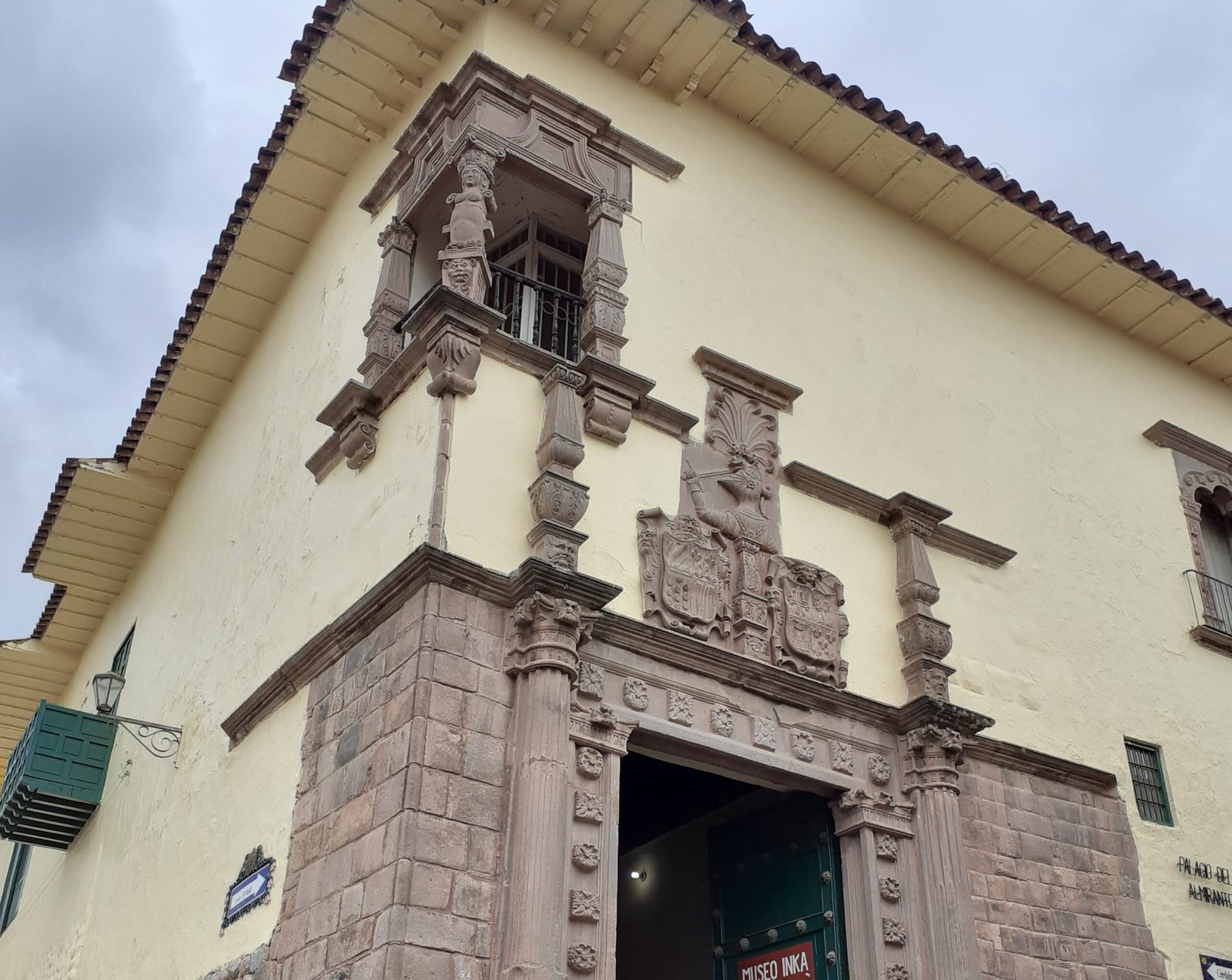 Historic façade of the Inka Museum in Cusco featuring the Dragon Ship relief detail.