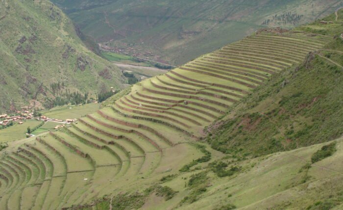 Travelers enjoying a half-day Pisac Ruins Hiking Tour with panoramic views.