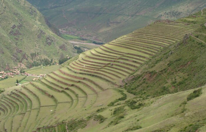 Travelers enjoying a half-day Pisac Ruins Hiking Tour with panoramic views.